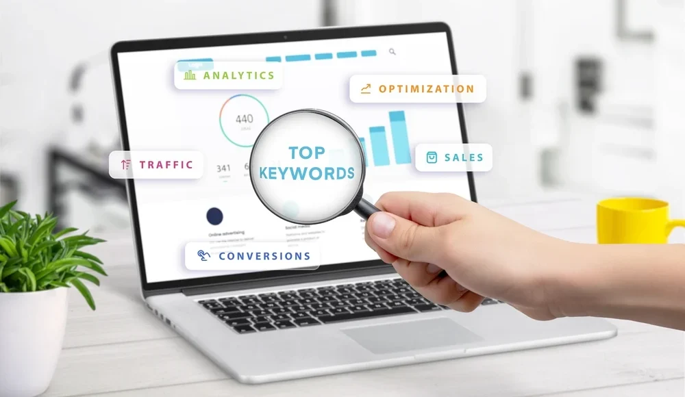 Magnifying glass over a laptop dashboard showing top keywords, a visual guide to keyword targeting and on page SEO