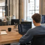 Does SEO require coding? Team members working at different technical levels in a co-working space