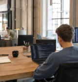 Does SEO require coding? Team members working at different technical levels in a co-working space
